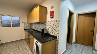 a kitchen with a sink and a counter top at Casa Kiri in Calheta