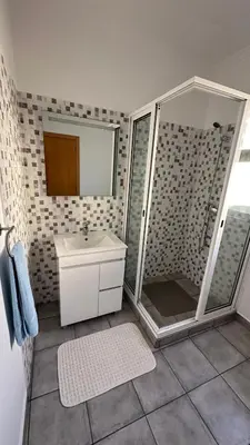 a bathroom with a shower and a sink at Casa Kiri in Calheta