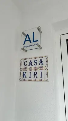 a sign on a wall next to a door at Casa Kiri in Calheta