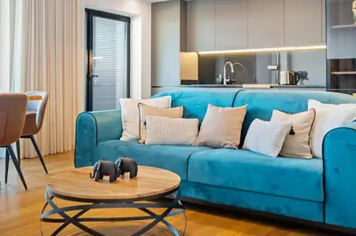 a blue couch in a living room with a table at City View Condo in Funchal