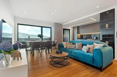 a living room with a blue couch and a table at City View Condo in Funchal