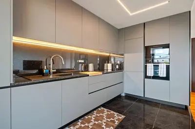 a kitchen with white cabinets and a sink at City View Condo in Funchal