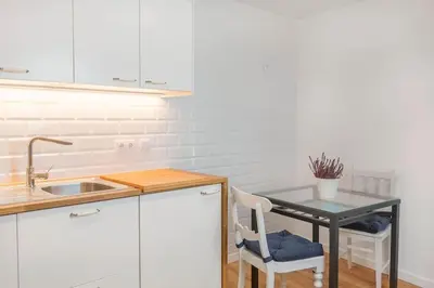a kitchen with a table and a small table with chairs at Atelier by Real Vision in Funchal