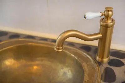 a brass sink with a faucet on a counter at Atelier by Real Vision in Funchal