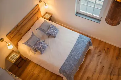 a bedroom with a bed with pillows and a window at Atelier by Real Vision in Funchal