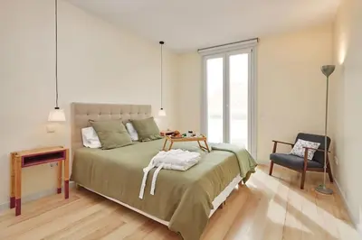 a bedroom with a bed with a table and a chair at DOMO by Real Vision in Funchal