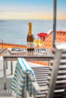 a table with a bottle of wine and two glasses at DOMO by Real Vision in Funchal