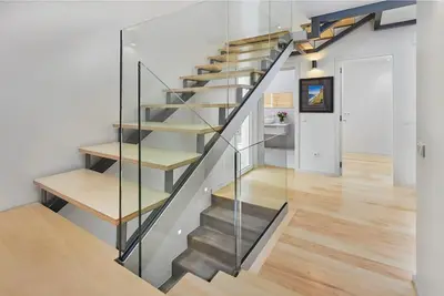 a metal staircase with glass railing in a house at DOMO by Real Vision in Funchal