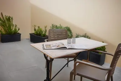 a table with two chairs and a book on it at DOMO by Real Vision in Funchal