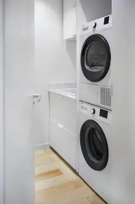 a white laundry room with two washer and dryer at DOMO by Real Vision in Funchal