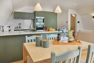 a kitchen and dining room with a wooden table at DOMO by Real Vision in Funchal