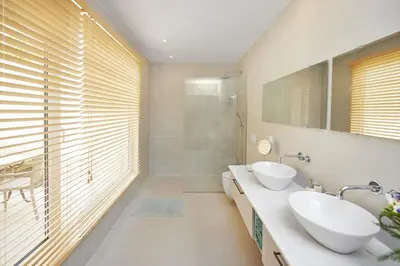 a bathroom with two sinks and a large window at DOMO by Real Vision in Funchal