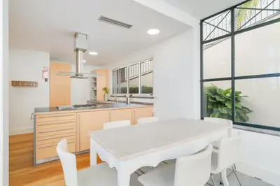 a kitchen and dining room with a white table and chairs at Sublime View Villa by Atlantic Holiday in Funchal