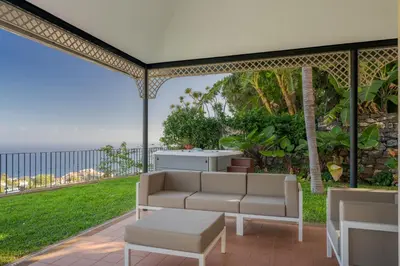 a patio with a couch and a view of the ocean at Sublime View Villa by Atlantic Holiday in Funchal