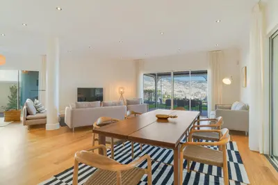 a living room with a wooden table and chairs at Sublime View Villa by Atlantic Holiday in Funchal