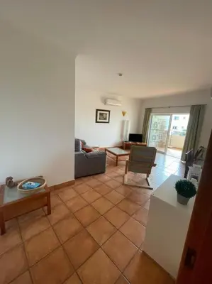 a living room with a couch and a table at Superbe appartement vue mer et falaises in Lagos