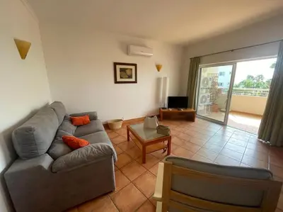a living room with a couch and a table at Superbe appartement vue mer et falaises in Lagos