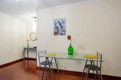 a dining room with a glass table and chairs at Cantinho dos Netos in Funchal