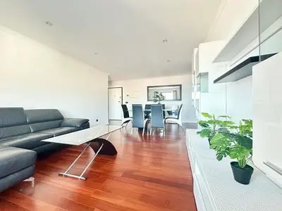 a bedroom with a green bed and a wooden floor at Rooms for Rent in Funchal in Funchal