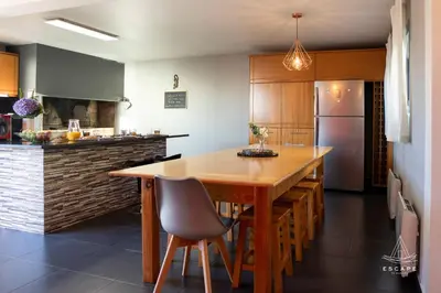 a black chair sitting in front of a desk at Villa Karibo by ESCAPE to Madeira in Achada de Cima