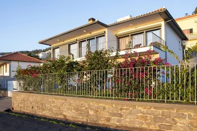 a white scooter parked in front of a house at Villa Karibo by ESCAPE to Madeira in Achada de Cima