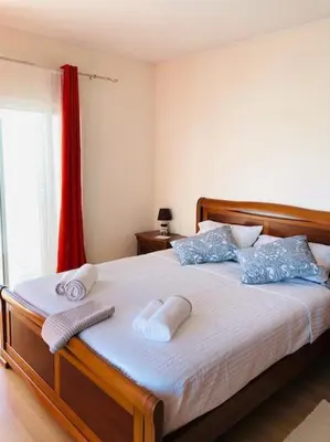 a bedroom with a bed with towels on it at DAR Arrifana- Stylish 4-Bedroom Villa -Ocean Views in Aljezur