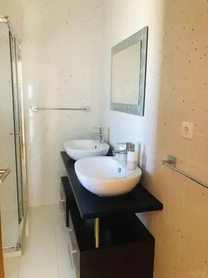 a bathroom with two sinks and a mirror on a counter at DAR Arrifana- Stylish 4-Bedroom Villa -Ocean Views in Aljezur