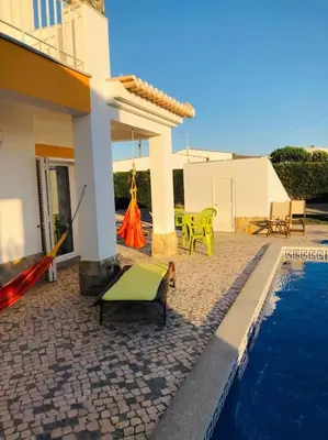 a house with a swimming pool next to a house at DAR Arrifana- Stylish 4-Bedroom Villa -Ocean Views in Aljezur