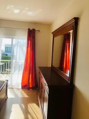 a room with a dresser with a mirror and a window at DAR Arrifana- Stylish 4-Bedroom Villa -Ocean Views in Aljezur