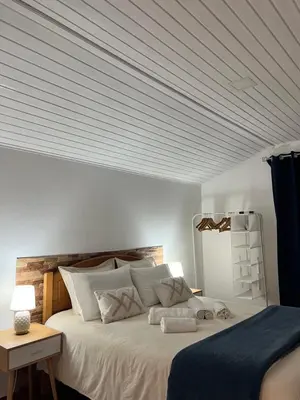 a bedroom with a large bed with a white ceiling at Quiet Cozy Apt MQ2 & Near Beach & Mountain View in Calheta
