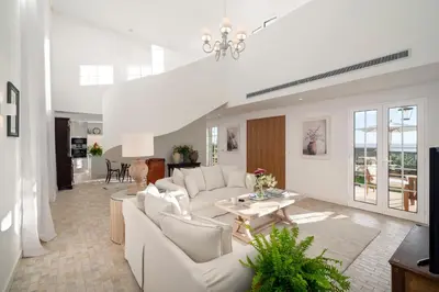 a living room with a white couch and a table at Quinta Marefe - On the stunning west coast in Paul do Mar