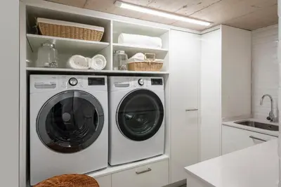 a white laundry room with a washer and dryer at Quinta Marefe - On the stunning west coast in Paul do Mar