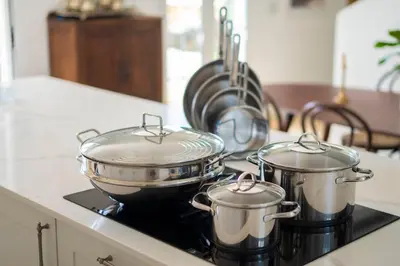 two pots and pans on a stove in a kitchen at Quinta Marefe - On the stunning west coast in Paul do Mar