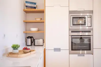 a kitchen with a stainless steel oven with a microwave at Paradise Beach Villa by Blue Diamond 18 in Lagos