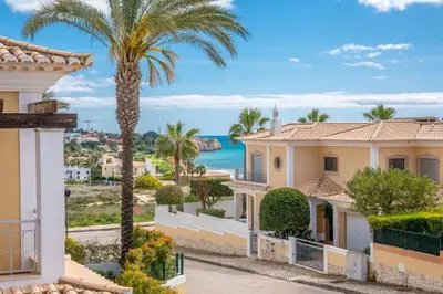 a house with palm trees and the ocean in the background at Paradise Beach Villa by Blue Diamond 18 in Lagos