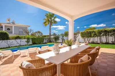 a patio with a table and chairs and a swimming pool at Paradise Beach Villa by Blue Diamond 18 in Lagos