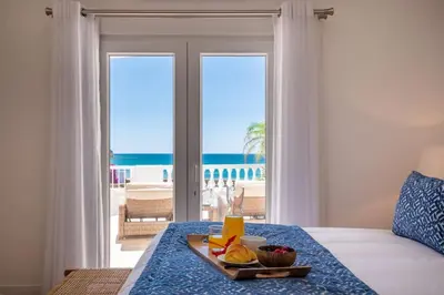 a tray of fruit on a table in front of the ocean at Beachfront Apartment Praia da Luz by Blue Diamond 23B in Luz