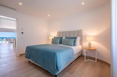 a bedroom with a bed and a table with a lamp at Beach View Apartment Praia da Luz by Blue Diamond 24-1F in Luz