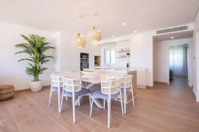 a kitchen and dining room with a table and chairs at Beach View Apartment Praia da Luz by Blue Diamond 24-1F in Luz
