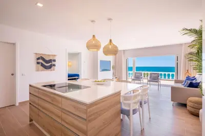 a kitchen and living room with a view of the ocean at Beach View Apartment Praia da Luz by Blue Diamond 24-1F in Luz