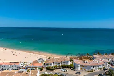 an aerial view of a beach with houses and the ocean at Beach View Apartment Praia da Luz by Blue Diamond 24-1F in Luz