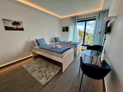 a living room with a couch and a table at SCIROCCO SUITES Madeira - Ocean View in Água de Pena