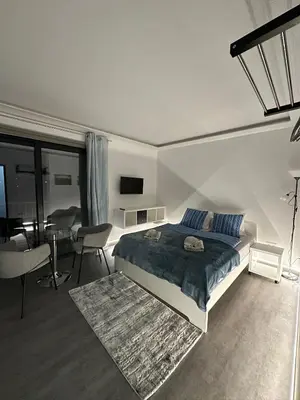 a bedroom with a bed and a dining room at SCIROCCO SUITES Madeira - Ocean View in Água de Pena