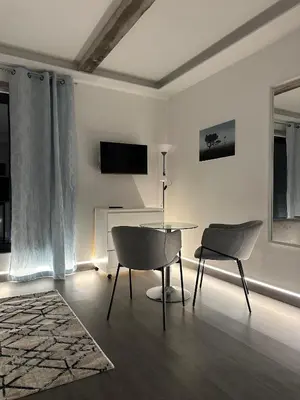 a living room with a table and two chairs at SCIROCCO SUITES Madeira - Ocean View in Água de Pena