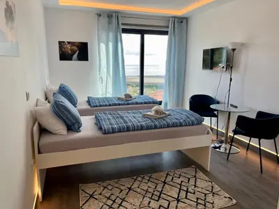 two beds in a room with a window at SCIROCCO SUITES Madeira - Ocean View in Água de Pena