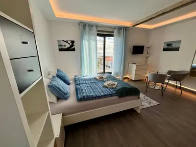 a small bedroom with a bed and a window at SCIROCCO SUITES Madeira - Ocean View in Água de Pena