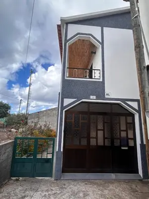 a building with two doors and a balcony at A Casa da Minha Mãe in Paul do Mar