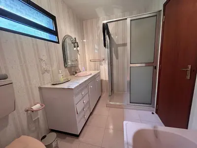 a bathroom with a shower and a sink and a mirror at A Casa da Minha Mãe in Paul do Mar