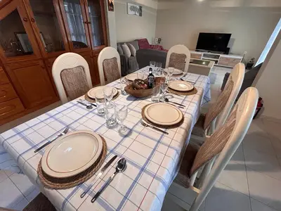 a dining room table with plates and glasses on it at A Casa da Minha Mãe in Paul do Mar