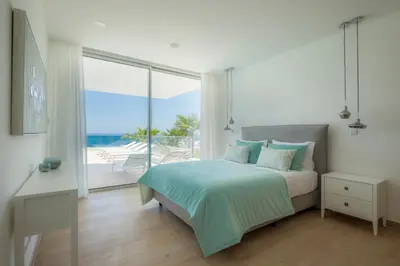 a bedroom with a bed with a view of the ocean at Beach View Villa by Blue Diamond 55 in Lagos